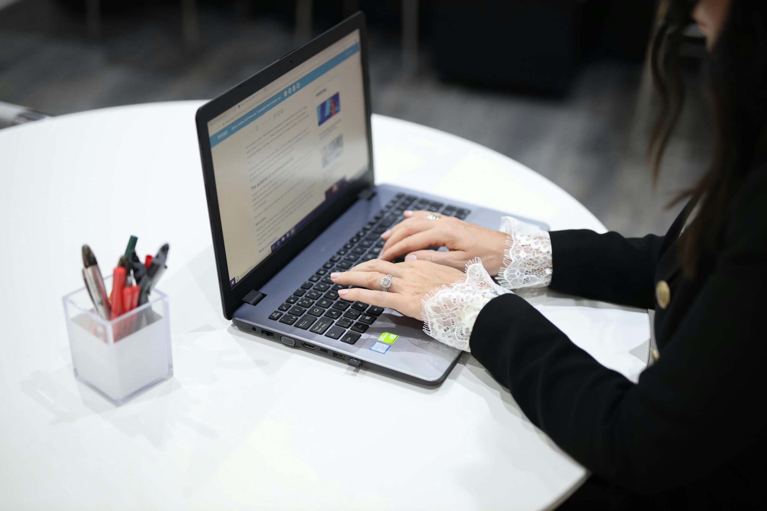 pexels-photo-3568689-3568689-1 A woman typing on a laptop in a contemporary office setting, showcasing technology and efficiency.